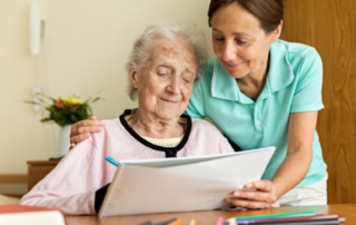 elderly woman doing occupational therapy with another woman